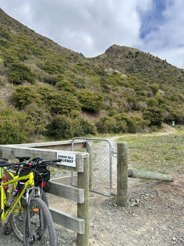 a bike parked next to a fence with a sign at Kurow Garden Retreat in Kurow