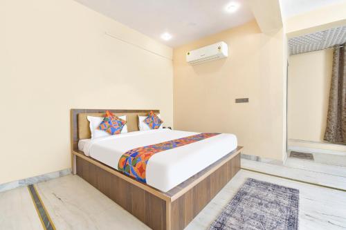 a bedroom with a bed and a window at FabHotel Pearl Square in Jaipur