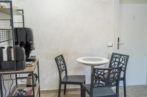 a dining room with two chairs and a table and a table and chairs at B&B Benvenuti al Sud in Crotone