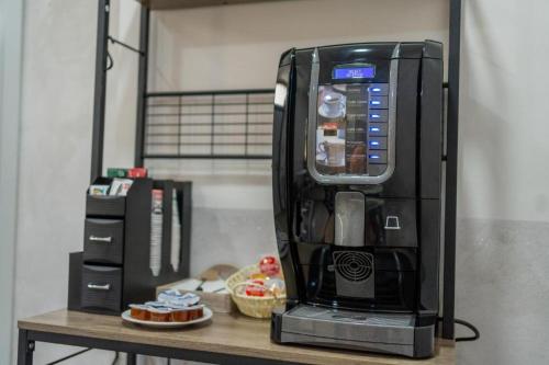 a black coffee machine sitting on a table at B&B Benvenuti al Sud in Crotone