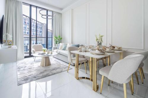 a living room with a table and a couch at Frank Porter - Samana Park Views in Dubai
