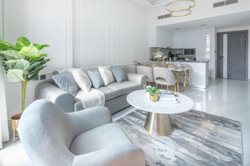 a living room with a couch and a table at Frank Porter - Samana Park Views in Dubai