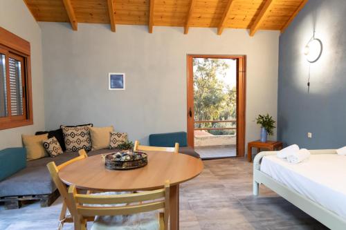 a room with a table and a bed and a couch at Mani Tigani View in Ayía Varvára