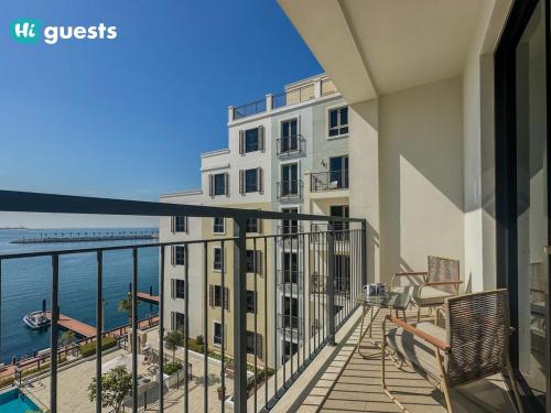 a balcony with a view of the ocean at HiGuests - Elegant 1BR Retreat with Sea View in La Rive in Dubai