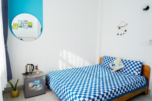 a bedroom with a bed with a blue and white checkered sheets at Xing Ocean Vũng Tàu in Vung Tau