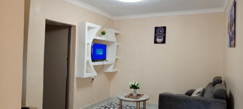 a living room with a couch and a television at EsMash Homes Air,bnb Lanet Nakuru in Nakuru