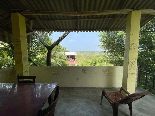 a room with a table and chairs and a view at Three Little Birds in Tangalle