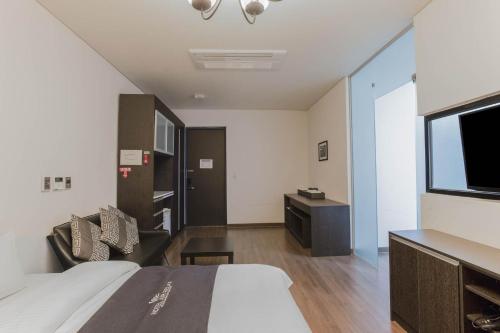 a hotel room with a bed and a television at Incheon Aiport Airrelax hotel in Incheon
