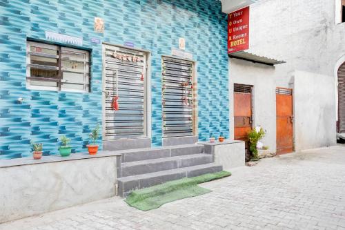 a blue building with stairs in front of it at Hotel O YOUR RESIDENCY in Ghaziabad
