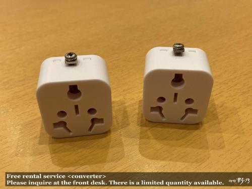 two white dice sitting on top of a wooden table at Onyado Nono Asakusa Natural Hot Spring in Tokyo
