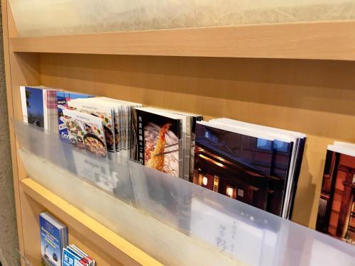 a shelf filled with books on top of it at Onyado Nono Asakusa Natural Hot Spring in Tokyo