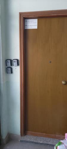 a brown door with a sign on top of it at La tana dell'amore, Torino sotto le stelle, camera matrimoniale o condivisa servitissima in Turin