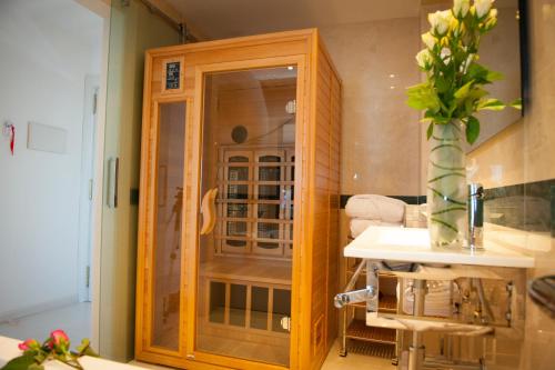 a kitchen with a wooden cabinet with a sink at Hotel Playas de Torrevieja in Torrevieja