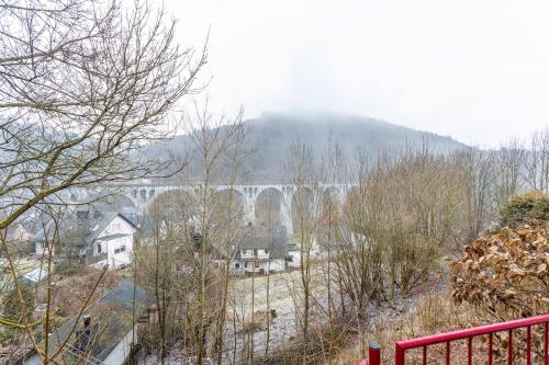 a bridge in the distance with houses and trees at Viadukt in Willingen
