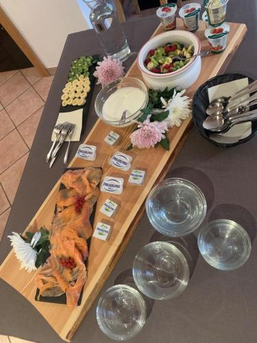a table with food and plates of food on it at Residence Garni Stella in San Vigilio Di Marebbe