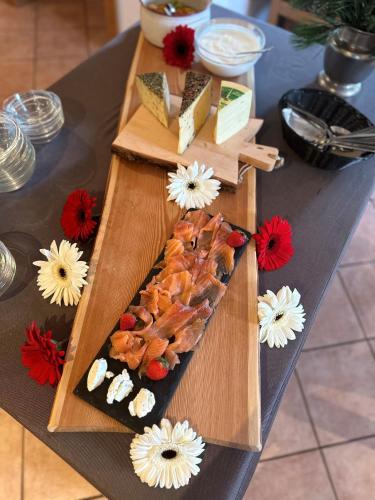 a cutting board with food on a table at Residence Garni Stella in San Vigilio Di Marebbe