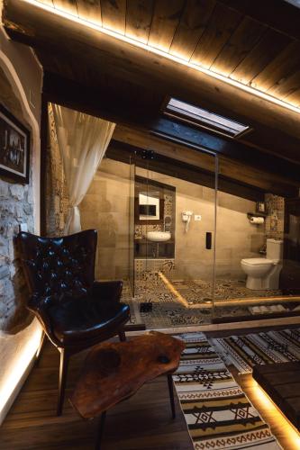 a room with a chair and a bathroom with a toilet at Tradita e Beratit in Berat