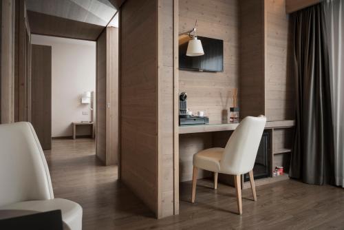 a room with a table and a white chair at Miramonti Park Hotel in Bormio