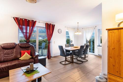 a living room with a couch and a table at Fewo Zur Piste in Willingen