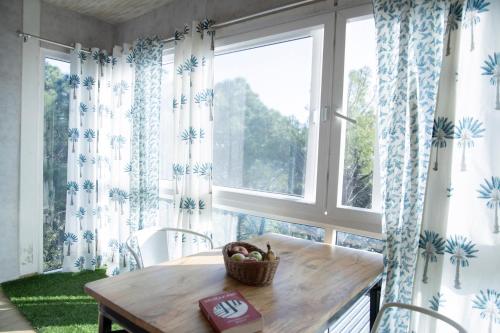 a dining room with a table and a large window at The Acanti, Dharamshala in Dharamshala