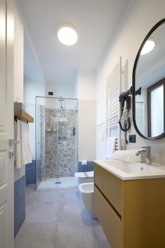 a bathroom with a sink and a toilet and a shower at La Corte Rental Room in Teramo