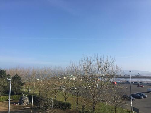 a parking lot with cars parked in a parking lot at Lakeview Guest House in Stranraer