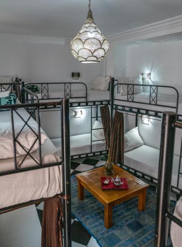 a room with four bunk beds and a table at Hostel Amour d'auberge in Marrakech