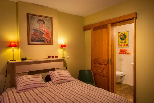 a bedroom with a bed and a sink and a toilet at B&B Chez tante Alice in Durbuy