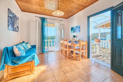 a living room with a blue couch and a table at Dolphin villa 2 in Gaios