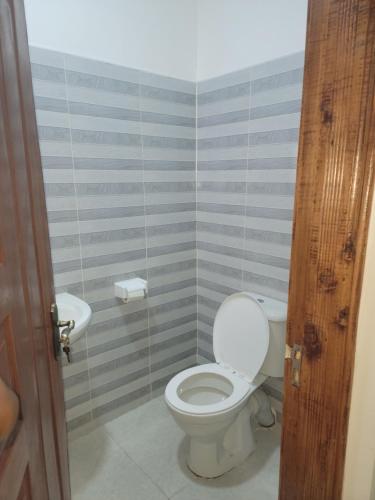 a bathroom with a toilet and a sink at Silverwood house 6 bedroom in Lotus Island