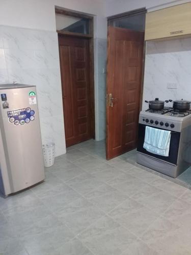 a kitchen with a stove and a refrigerator at Silverwood house 6 bedroom in Lotus Island