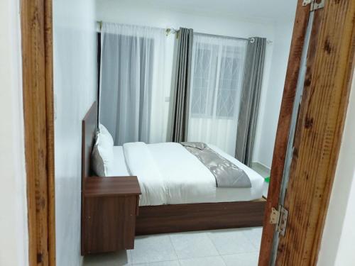 a bedroom with a bed and a mirror at Silverwood house 6 bedroom in Lotus Island