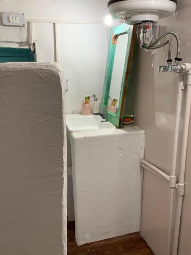 a small bathroom with a sink and a mirror at The Nook, Sainj in Sainj