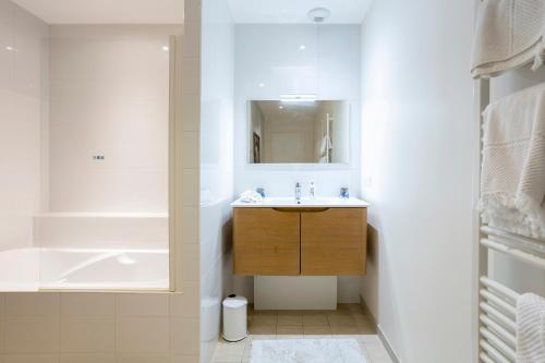 a bathroom with a sink and a mirror at Les logis de Kergoulou in Concarneau