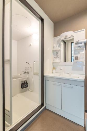 a bathroom with a shower and a sink at Cozy Stay Sapporo Hongodori 605 in Sapporo