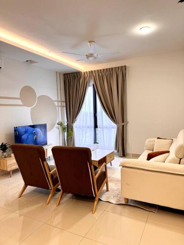 a living room with a table and a couch at The Apple Melaka in Melaka