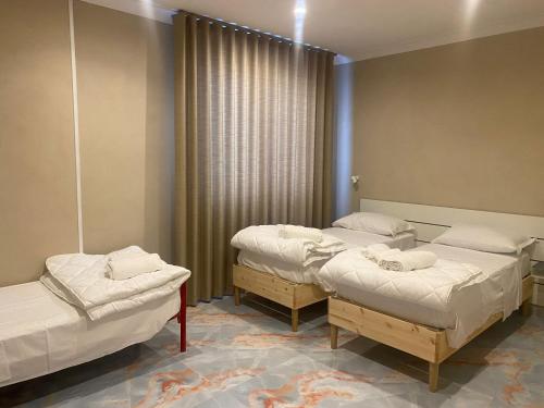 a hospital room with three beds and a window at Business House in Naples