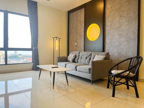 a living room with a couch and a table at The Apple Melaka in Melaka