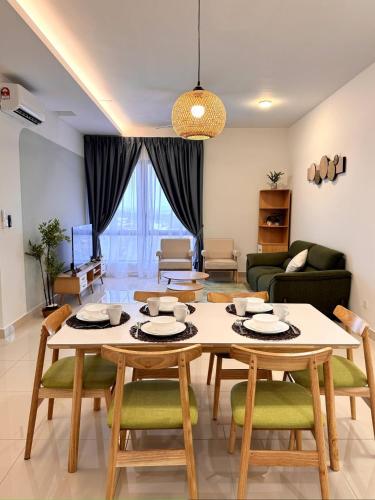 a living room with a table and chairs at The Apple Melaka in Melaka