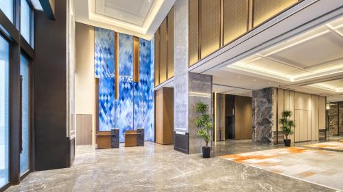 a lobby with a large painting on the wall at Holiday Inn Express Rugao City Center, an IHG Hotel in Nantong