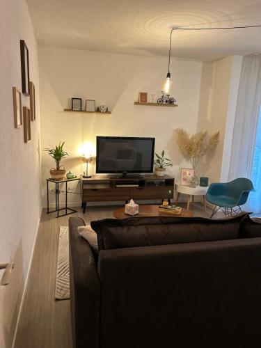 a living room with a couch and a flat screen tv at Niort Home in Niort