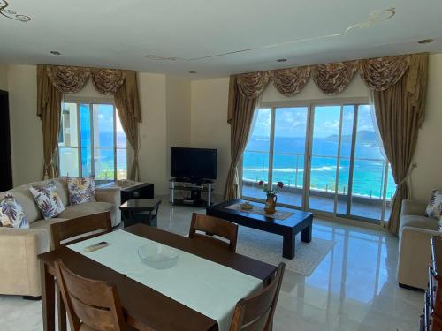 a living room with a couch and a table at Ocean Pearl Villa in Anse Royale