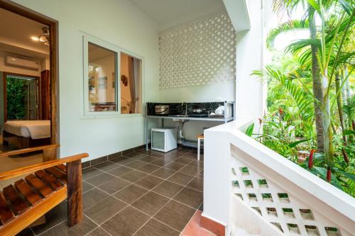 a room with a staircase and a kitchen with plants at Palma Resort in Phu Quoc