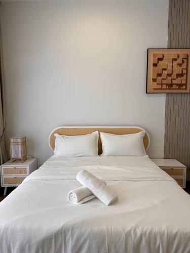 a bed with two rolls of toilet paper on it at The Apple Melaka in Melaka