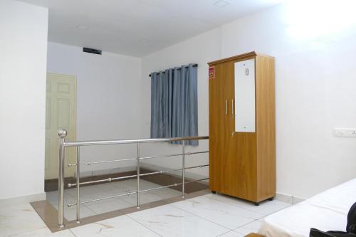 a room with a wooden partition and a metal railing at Hill Breeze Homestay in Anaviratty