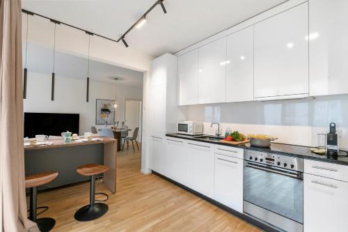 a kitchen with white cabinets and a counter at Novos Contrada in Lugano