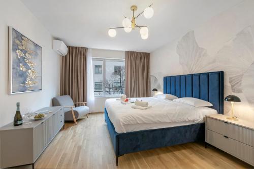 a bedroom with a large bed with a blue headboard at Novos Contrada in Lugano
