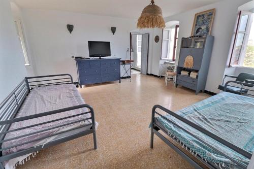 - une chambre avec 2 lits et une télévision dans l'établissement Casa Nessa - Résidence familiale, à Nessa