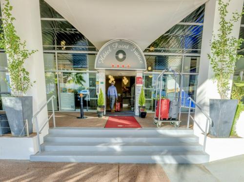 an entrance to a store with stairs and luggage at Hôtel Point France in Arcachon