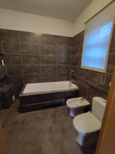 a bathroom with a tub and a toilet and a sink at Roztoczańska Posiadłość in Lipsko-Polesie